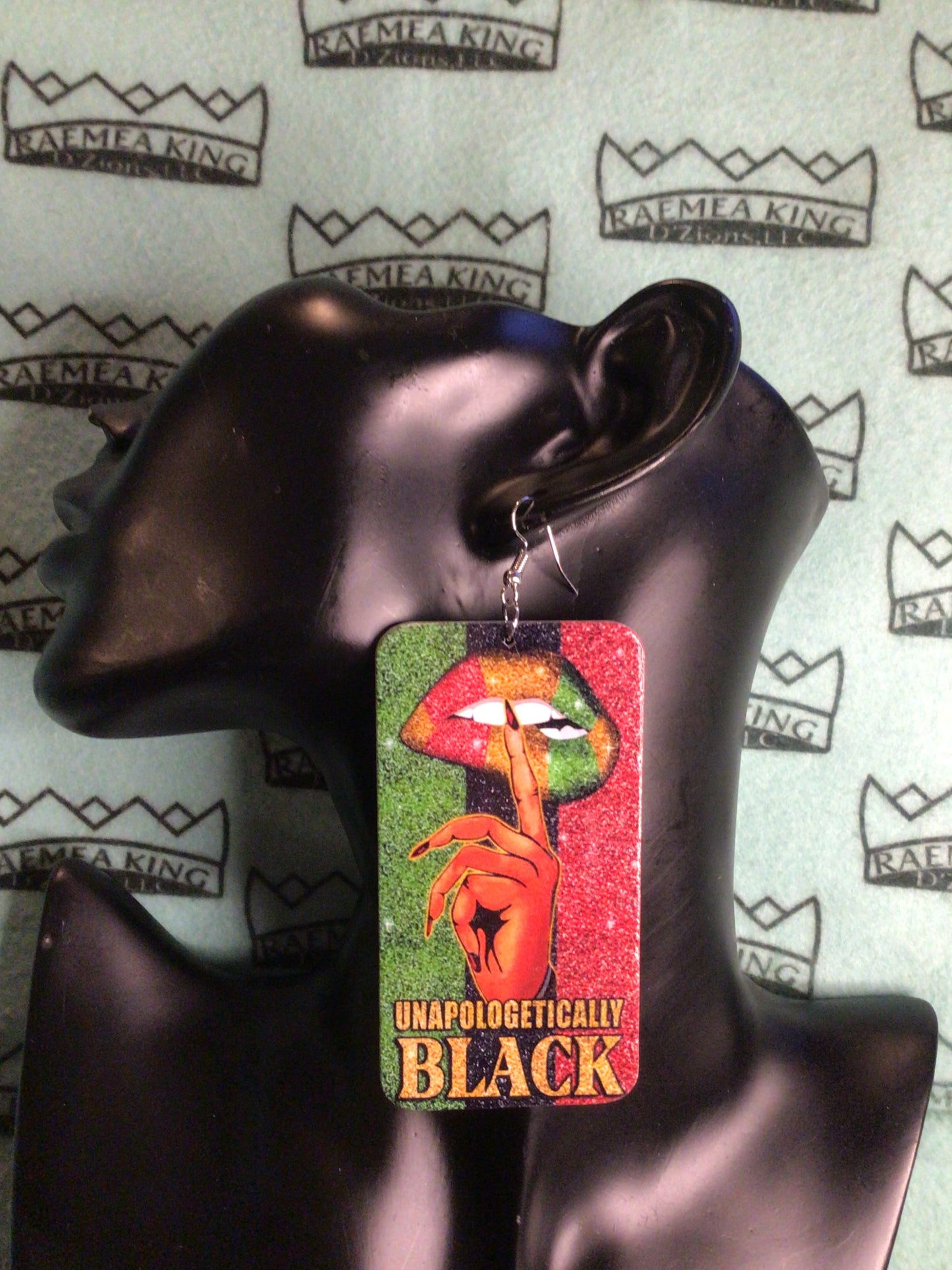 Unapologetically Black with Finger up to a Lady's Lips