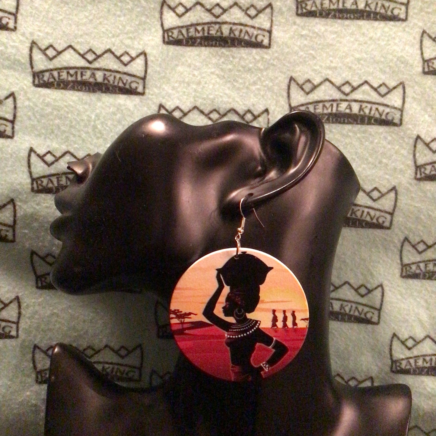 African Lady with hand on Hip and hand on Basket on Head