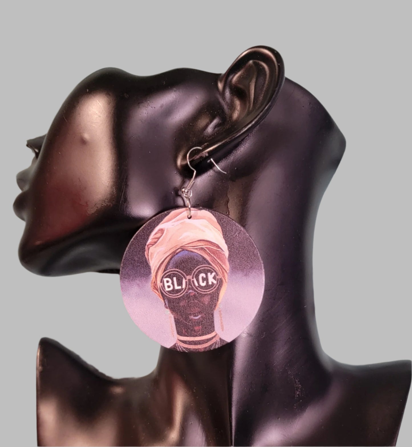 Lady with Glasses that says BLACK, with Gold Headwrap